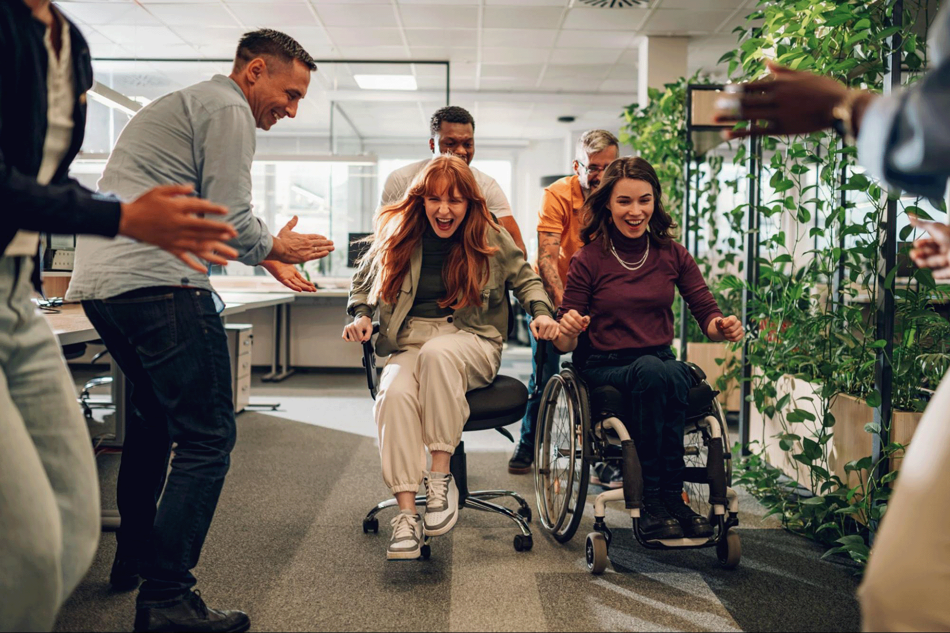 Employees participating in an inclusive workplace training session, collaborating around a visual framework designed to foster psychological safety, empathy, and effective communication.