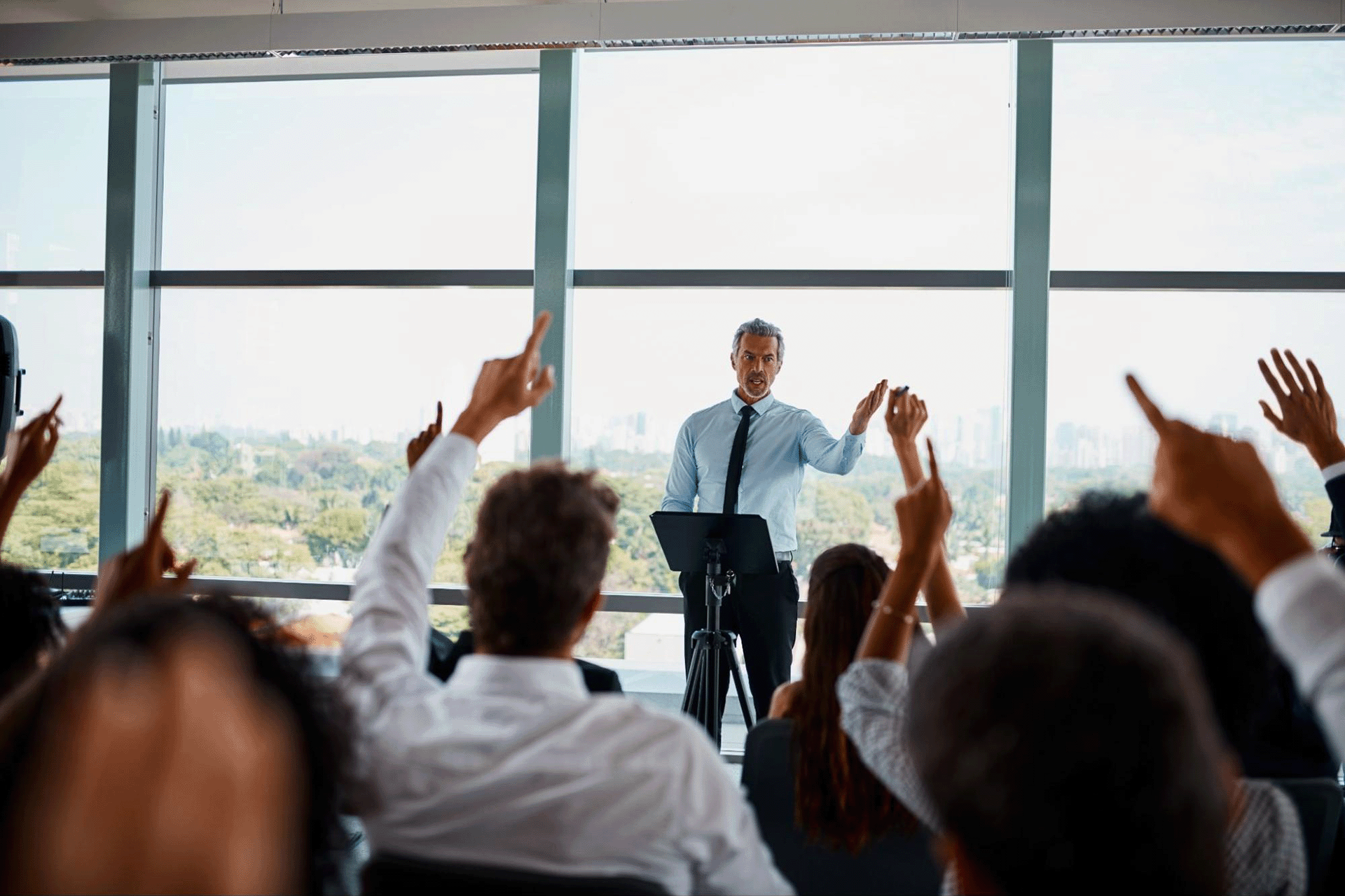 Leader standing up in front of corporate team and navigating workplace culture transformation