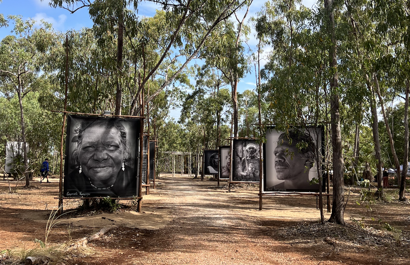 photo portraits in black and white lining a path through Garma festival