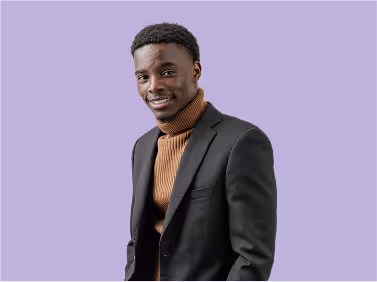 Man in a blazer smiling against a light purple background