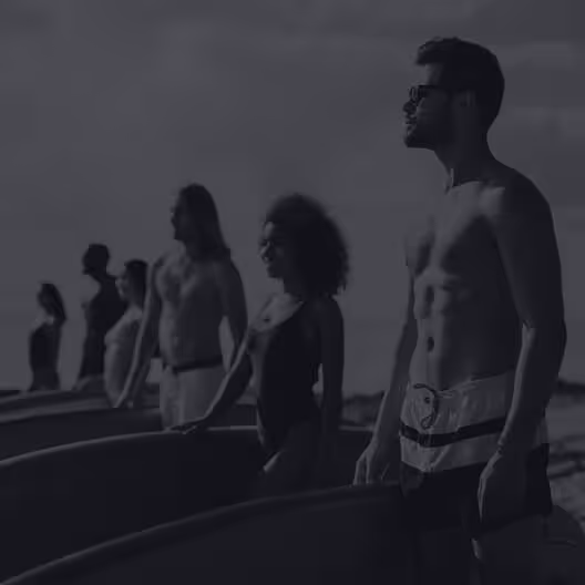People on beach with surfboards