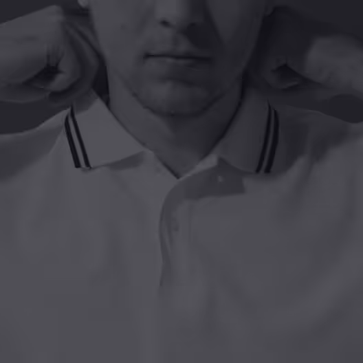 Man adjusting collar of polo shirt