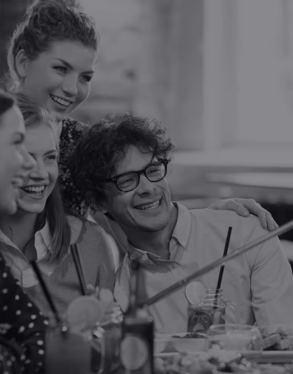 Group of friends posing for a selfie in a restaurant