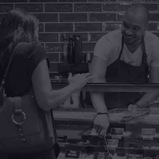 Woman being served at a deli counter