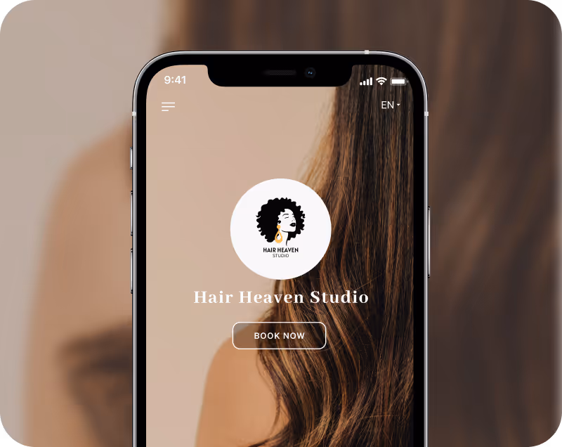 Mobile phone screen showing Hair Heaven Studio booking app with a background of long wavy brown hair.