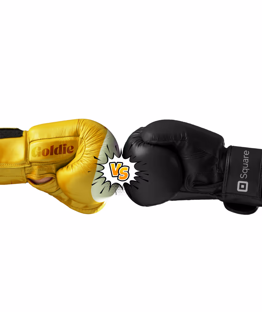 Yellow boxing glove labeled 'Goldie' and black boxing glove labeled 'Square' facing each other with a 'VS' graphic in between.