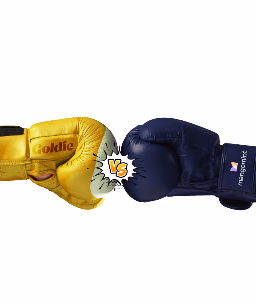 Yellow boxing glove labeled 'Goldie' facing a navy blue boxing glove labeled 'mangomint' with a 'VS' graphic between them.