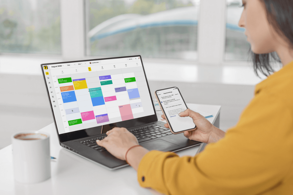 Beauty professional using Goldie on a laptop and phone to manage salon appointments and get started with online booking.