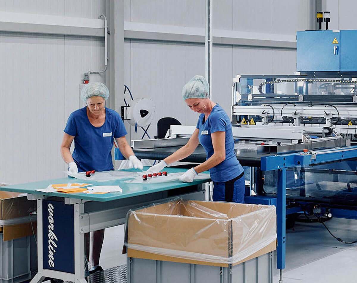 Mehrere Mitarbeiter der Tesseraux GmbH in einer Fertigungshalle des Unternehmens bei derQualitätskontrolle