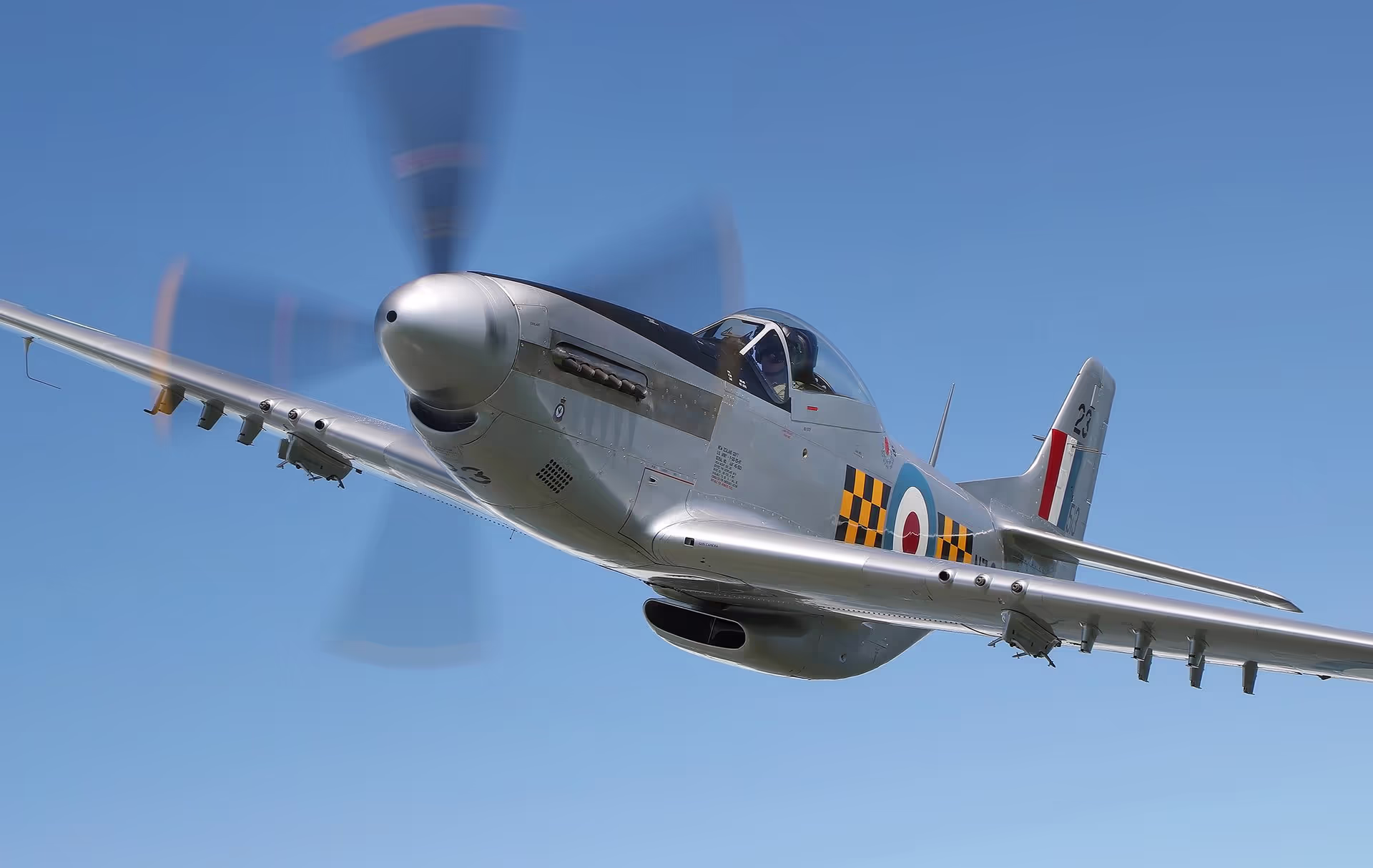 A historic plane flying on a perfect clear sky day.