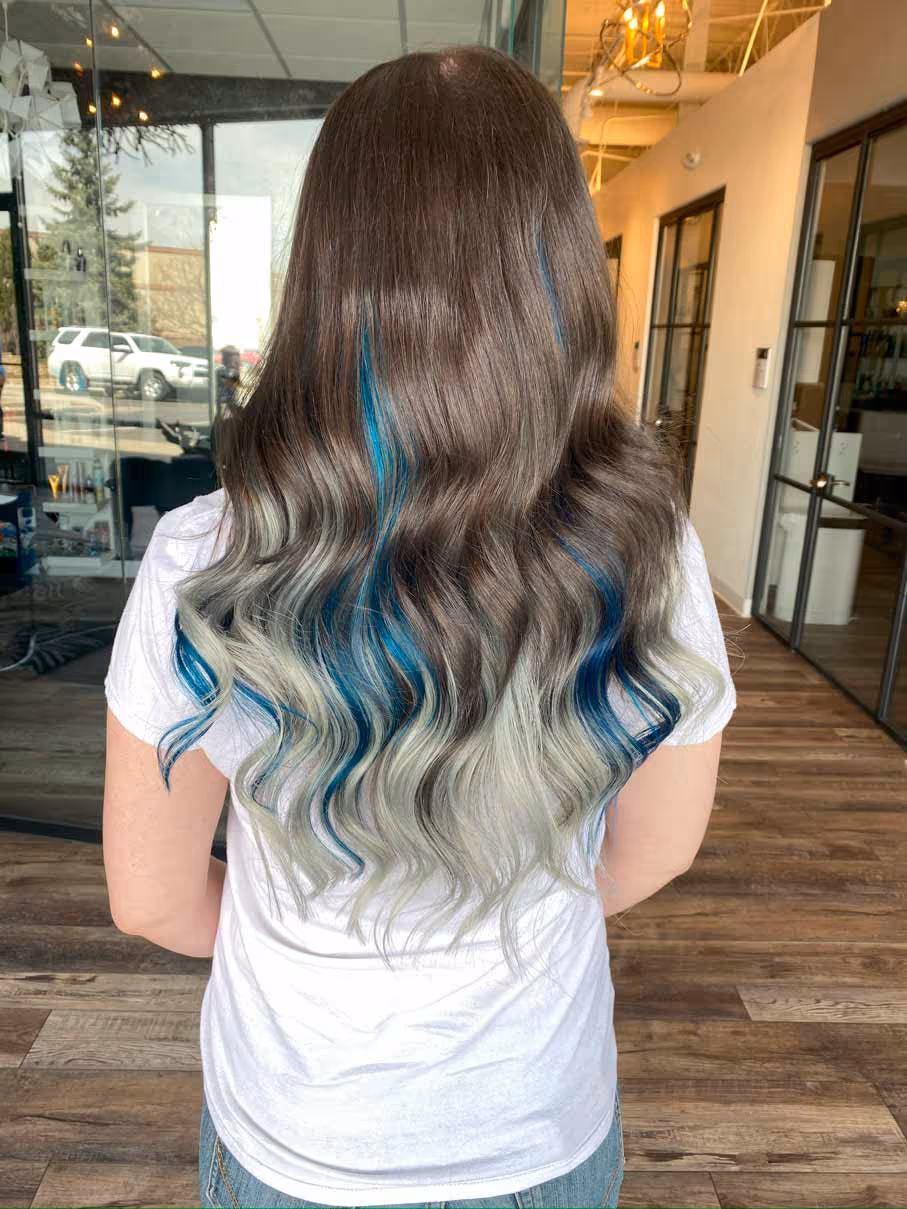 Custom colored blue ombre hair extensions showcasing seamless blend with natural hair at Denver's premier extension salon