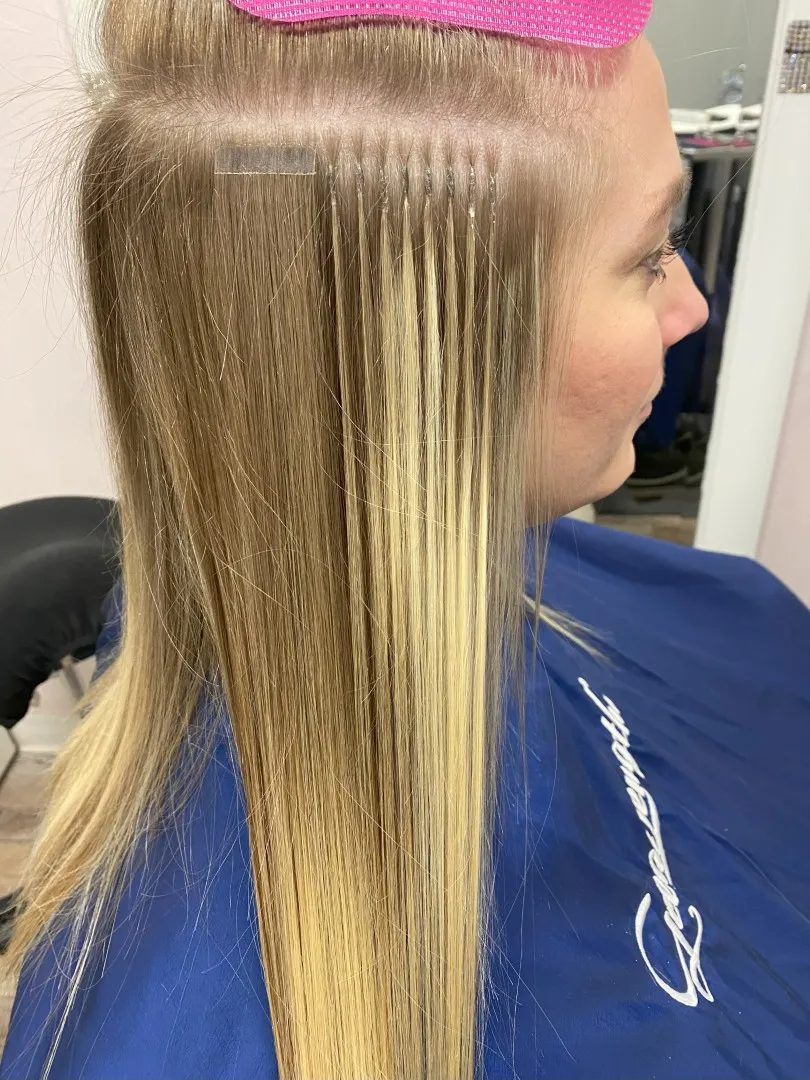 Rows of hand-placed K-tip bonds on blonde hair at Jo Hearts Hair