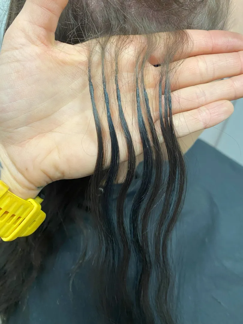 Close-up of small keratin bonds held in Jo's hand