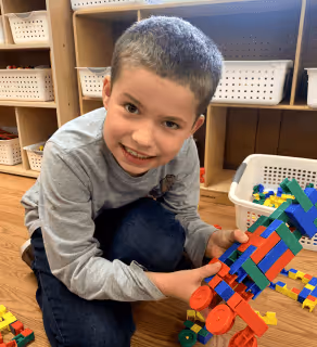 Happy boy playing with toys