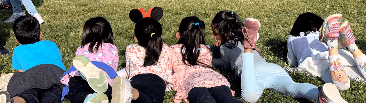 Children sitting outside during summer school