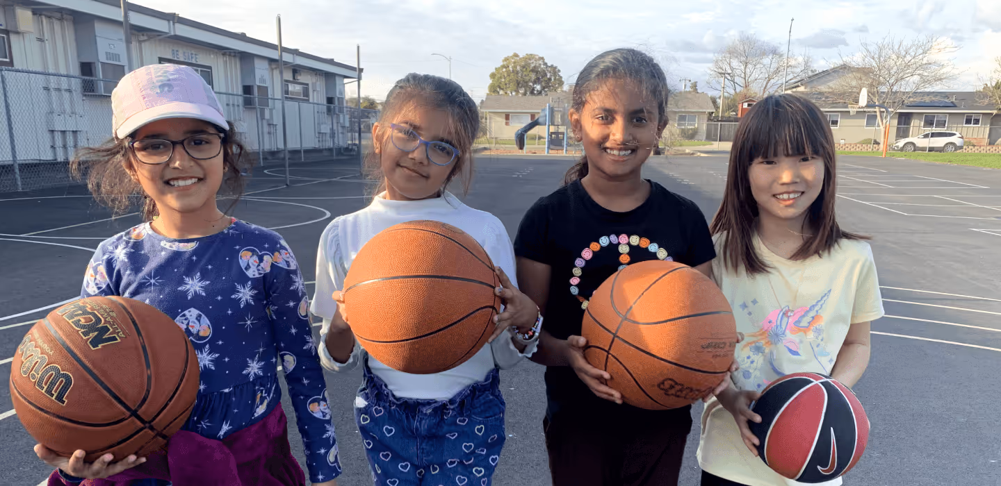 Happy children playing basketball