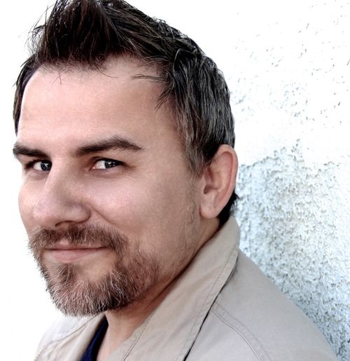 Trainer Chris Silber smirking to the camera.