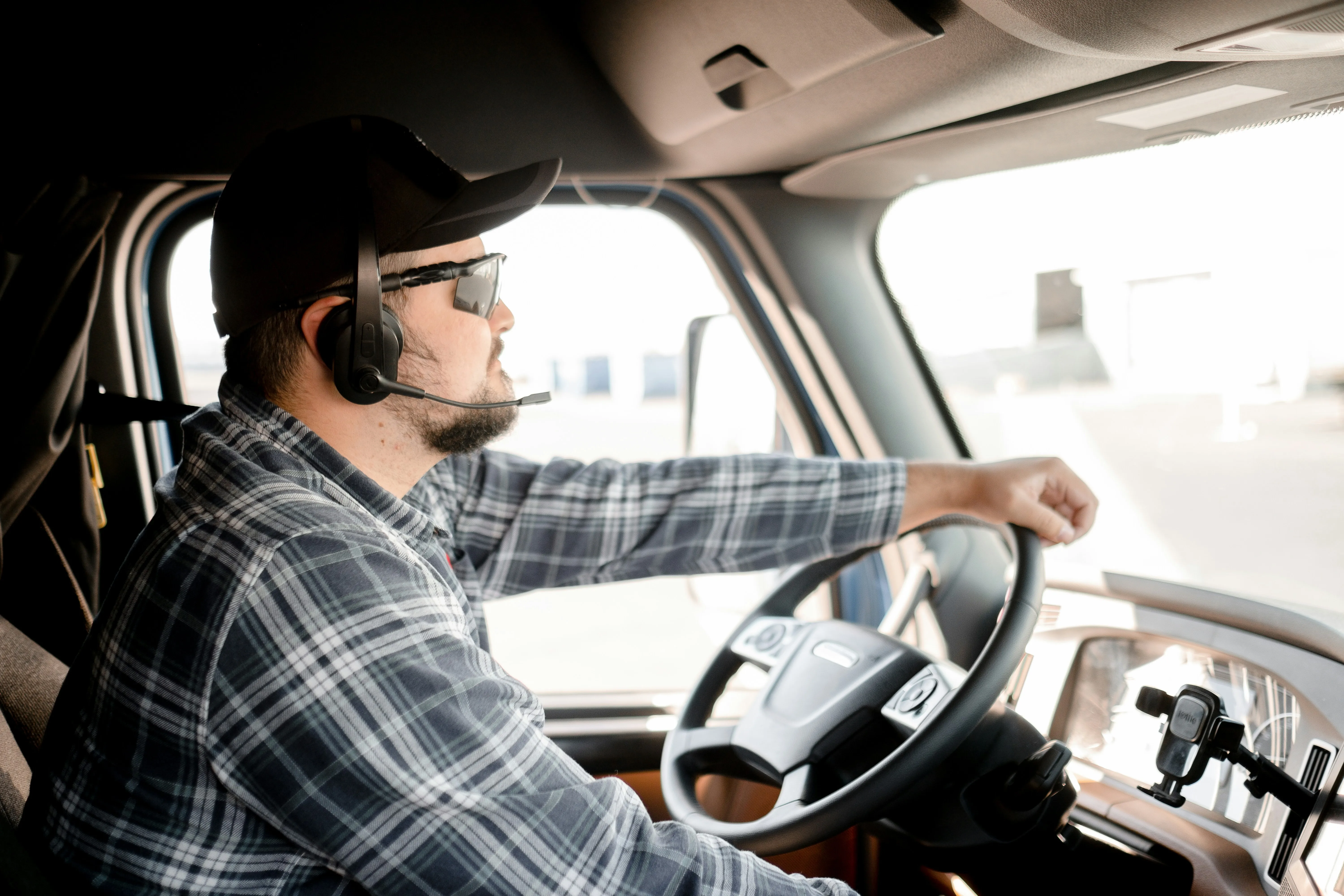 a truck driver in cab with headset on