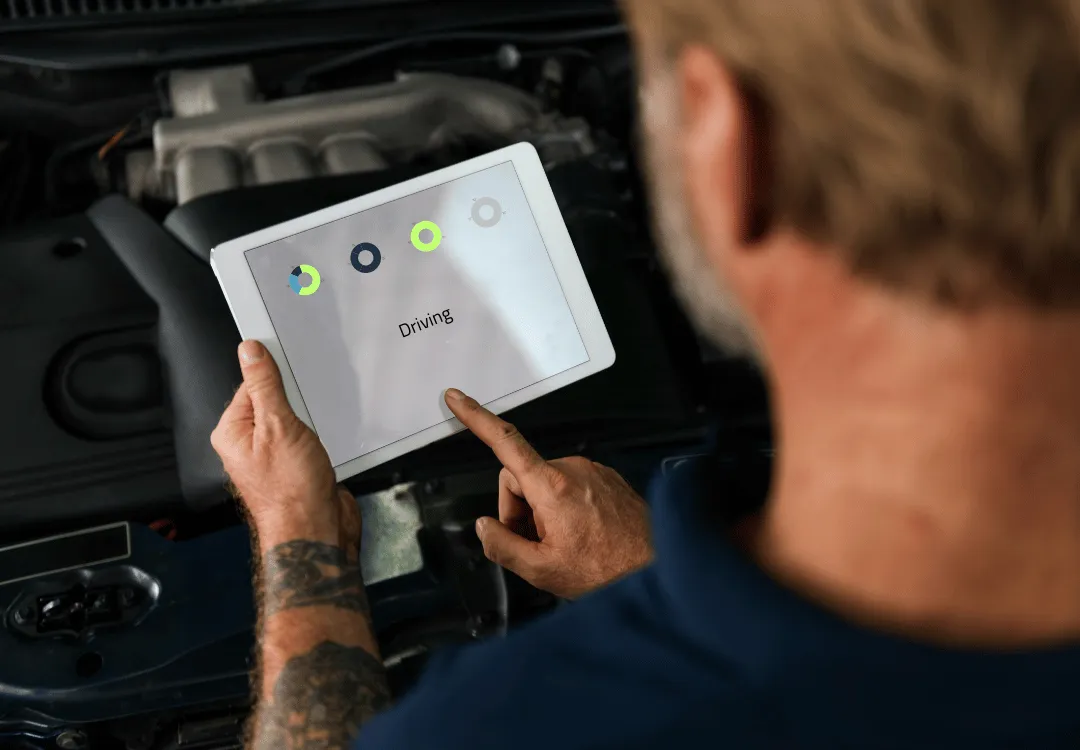 a driver looking at an ELD logging tablet