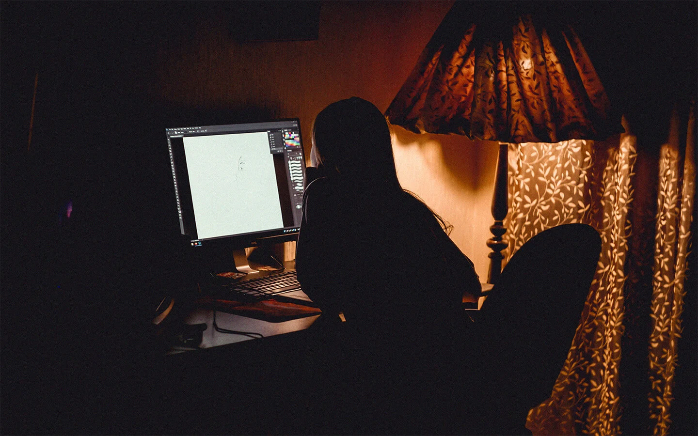 Australian freelancer working late at night on a computer, symbolising the dedication of local talent supported by Unjumble’s mission on the Our Perspective page.