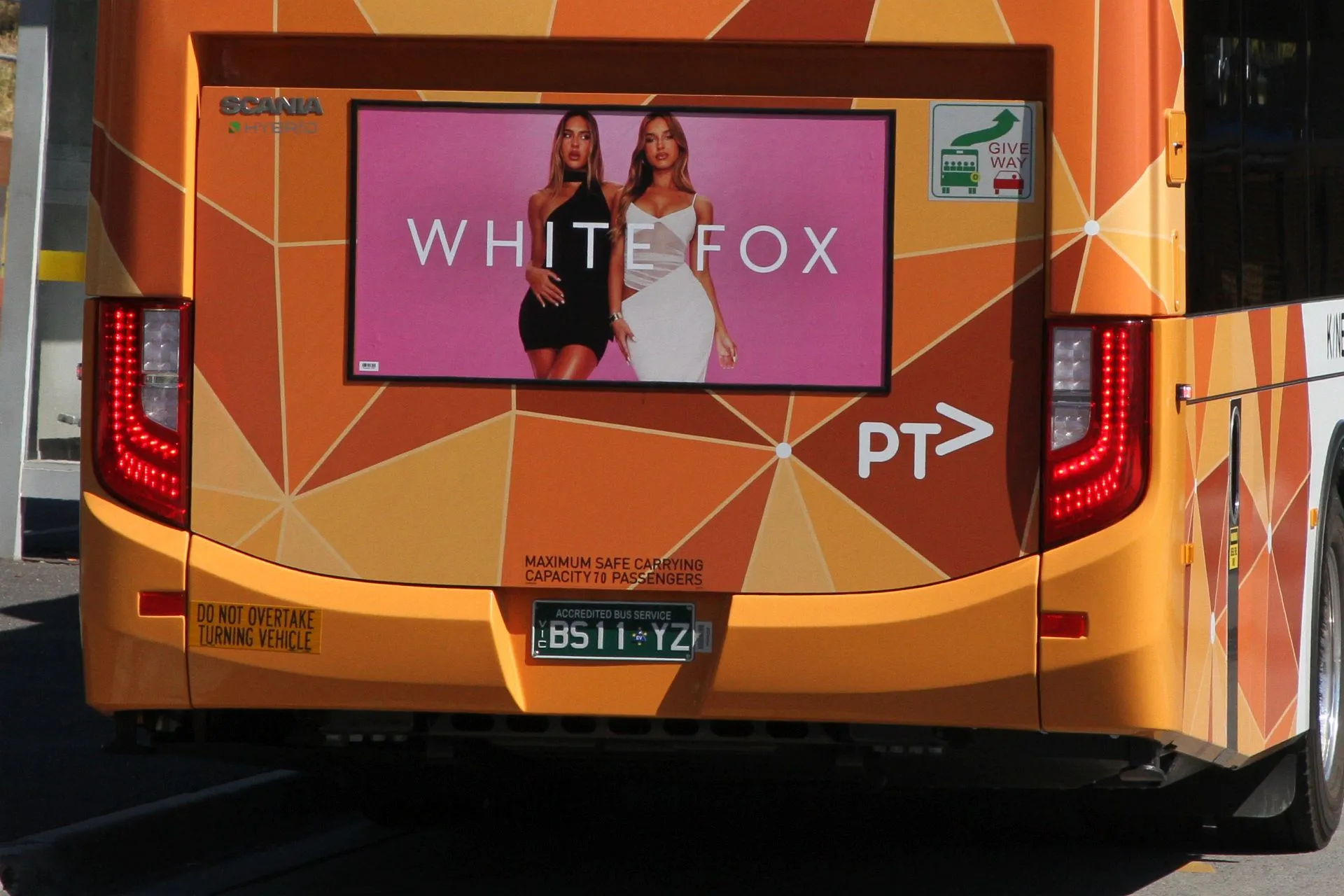 Advertisement for White Fox fast fashion displayed on the back of a bus in Victoria, Australia, featuring the brand’s model and consistent creative style.