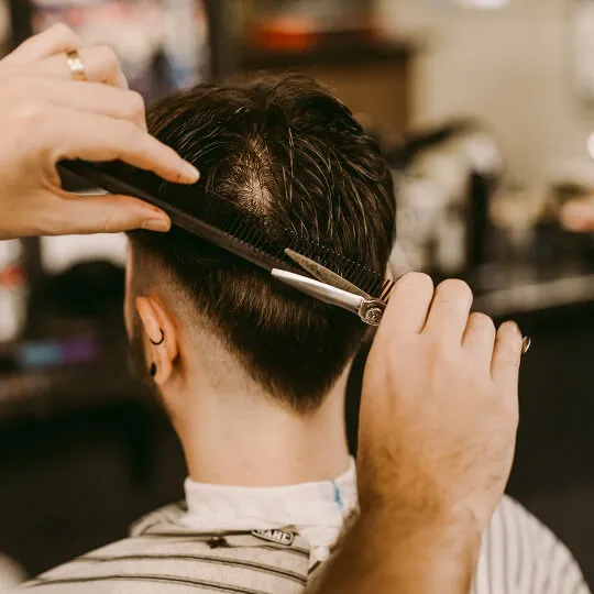 Dan and Nick, Hills barbers at Wiseguys Glenhaven, giving men’s haircuts.