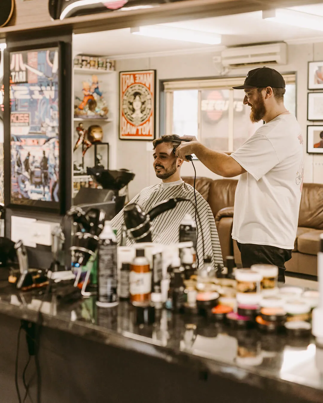 Dan and Nick, Hills barbers at Wiseguys Glenhaven, giving men’s haircuts.