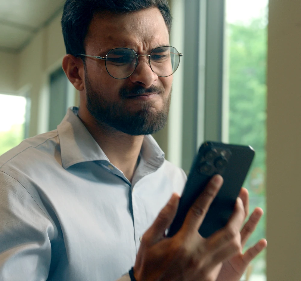 Man looking disappointed at her phone