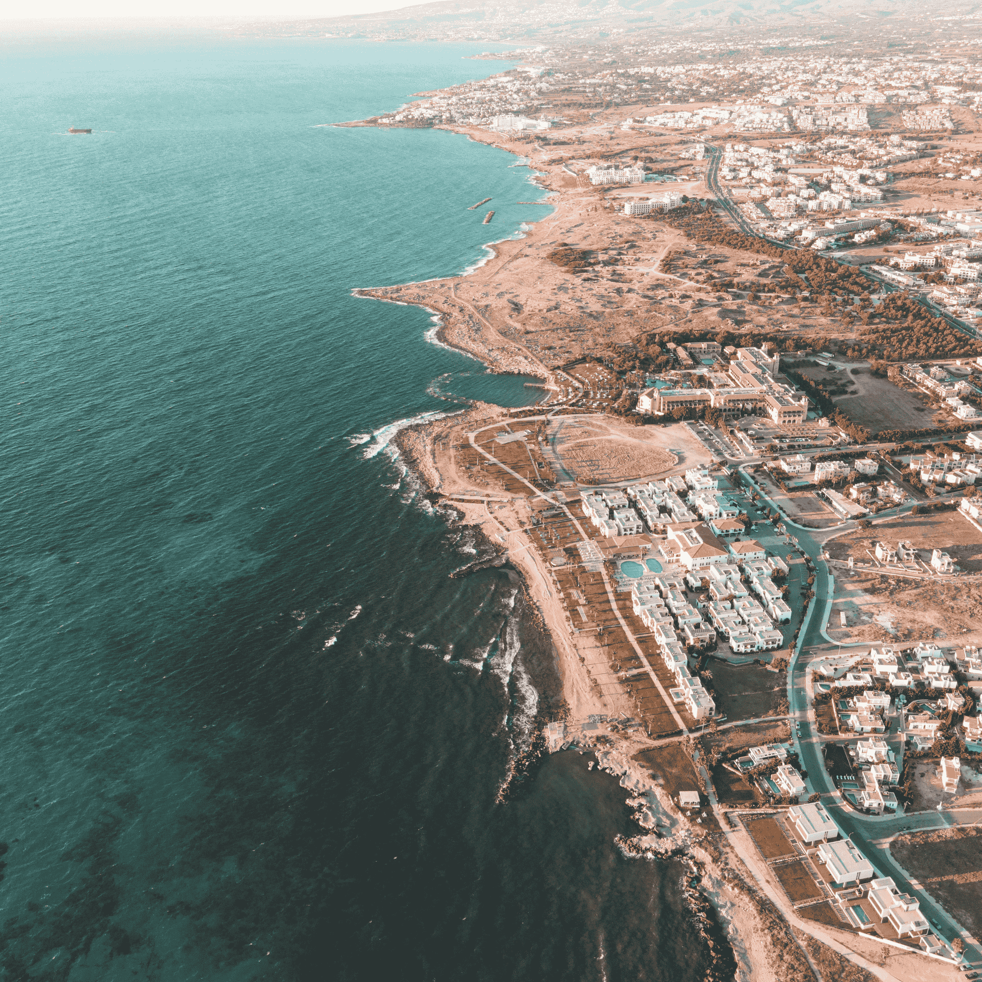 Aerial view of Cyprus coastline with luxury properties and business districts, symbolising the country’s attractive tax environment and shareholder-friendly dividend distribution policies.