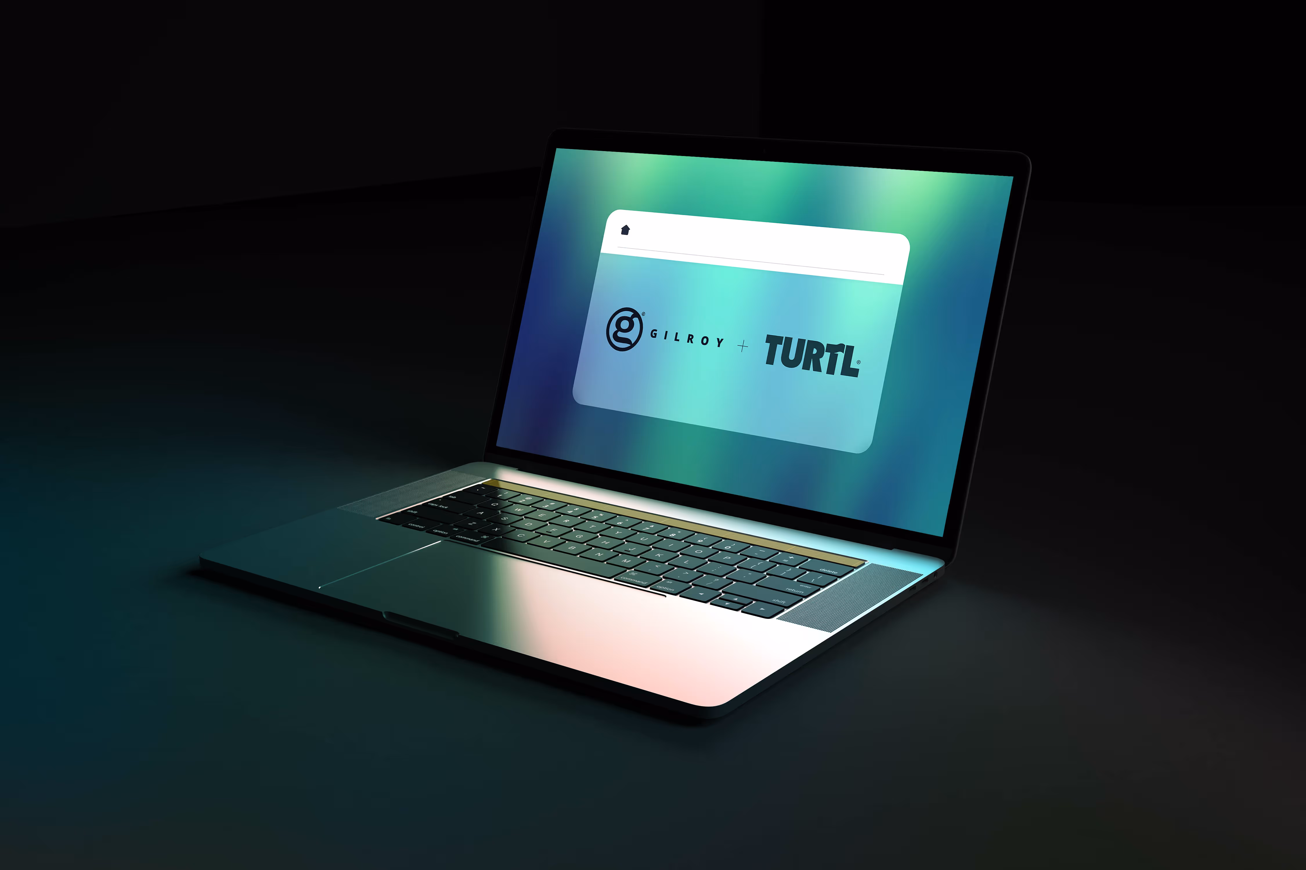A laptop showing the Gilroy and Turtl logo lock-up