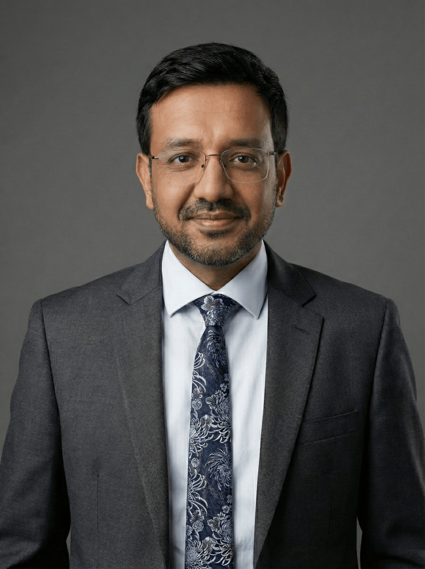 Dr Akhtar sitting in study