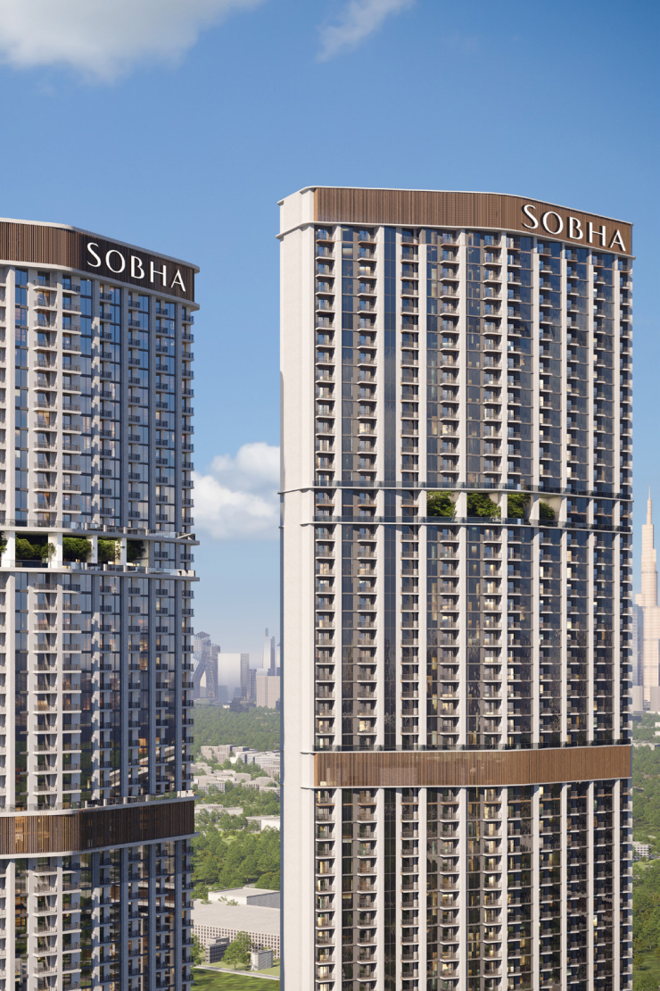 Twin towers of 360 Riverside Crescent at Sobha Hartland II, featuring modern high-rise architecture with balconies and greenery against a skyline view of Dubai