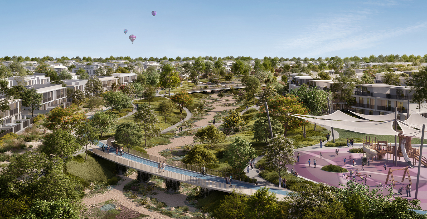 Velora 2 townhouses at The Valley by Emaar, showing a lush green community park with a walking bridge, modern residential units, and a children’s playground