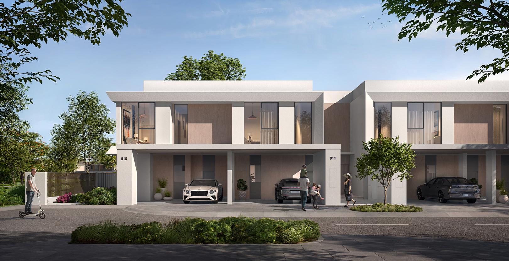 Modern townhouses with luxury cars parked in the driveway and people enjoying the street in Velora 2 by Emaar
