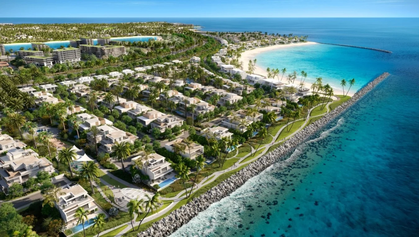 Aerial view of luxurious beachfront villas surrounded by greenery and turquoise waters at DAMAC Islands, Dubailand