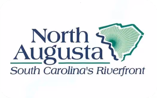 Logo with text 'North Augusta South Carolina's Riverfront' next to a stylized green outline of South Carolina with radiating lines.