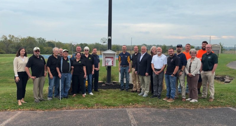 Lower Salford Township staff and officers next to a public AED cabinet in a township park