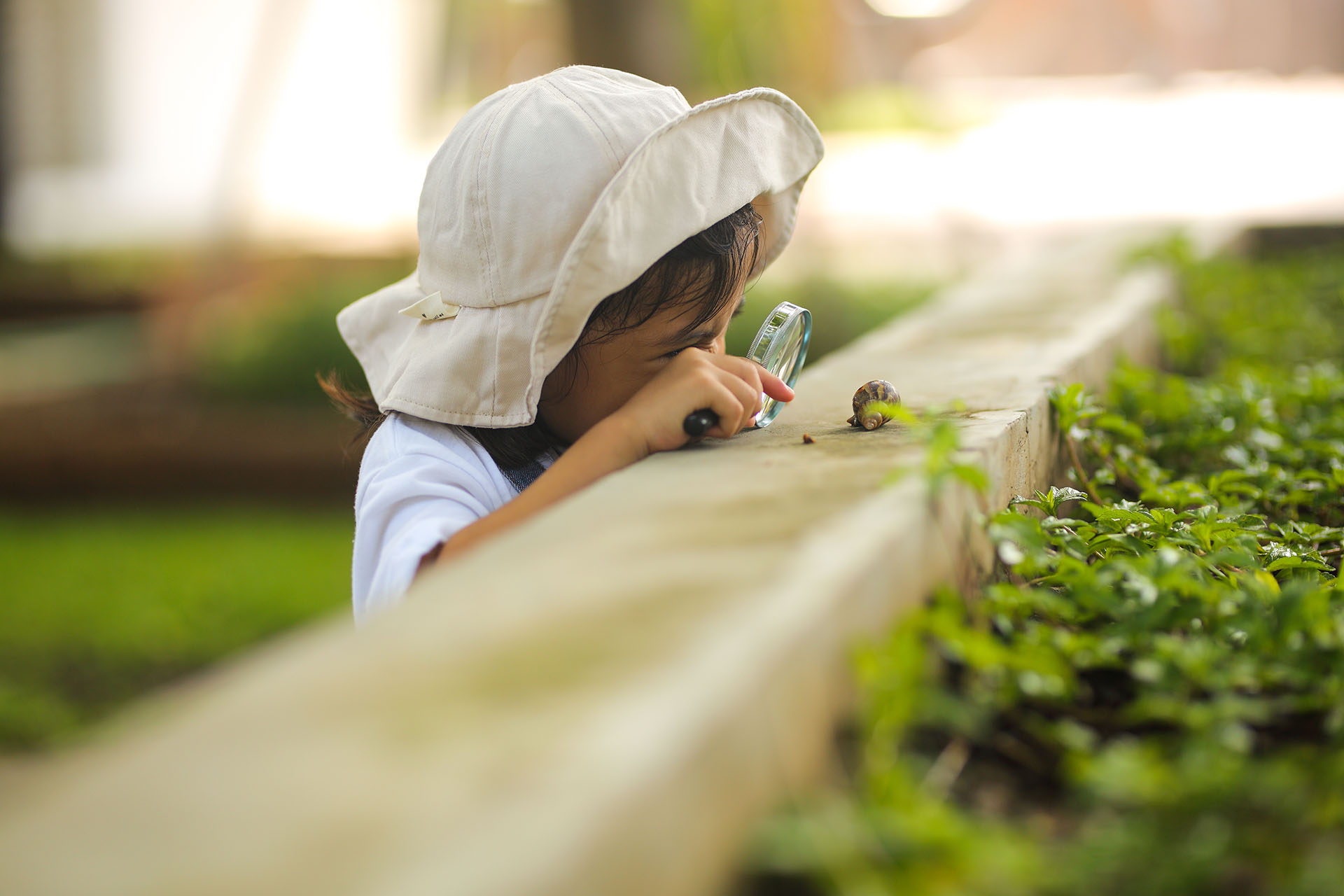 A child engaging in a spring nature scavenger hunt.