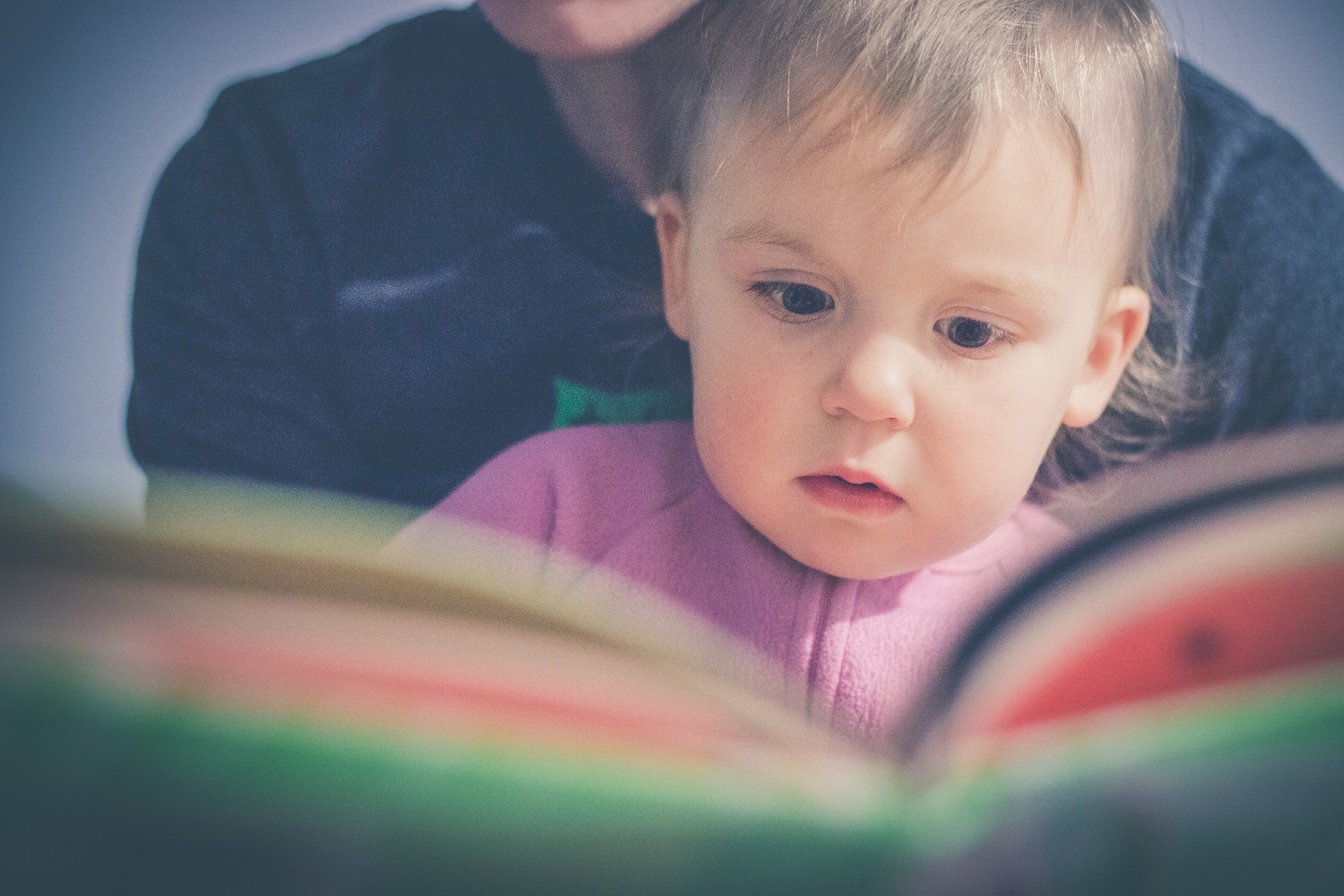 A parent and child reading together to support early literacy