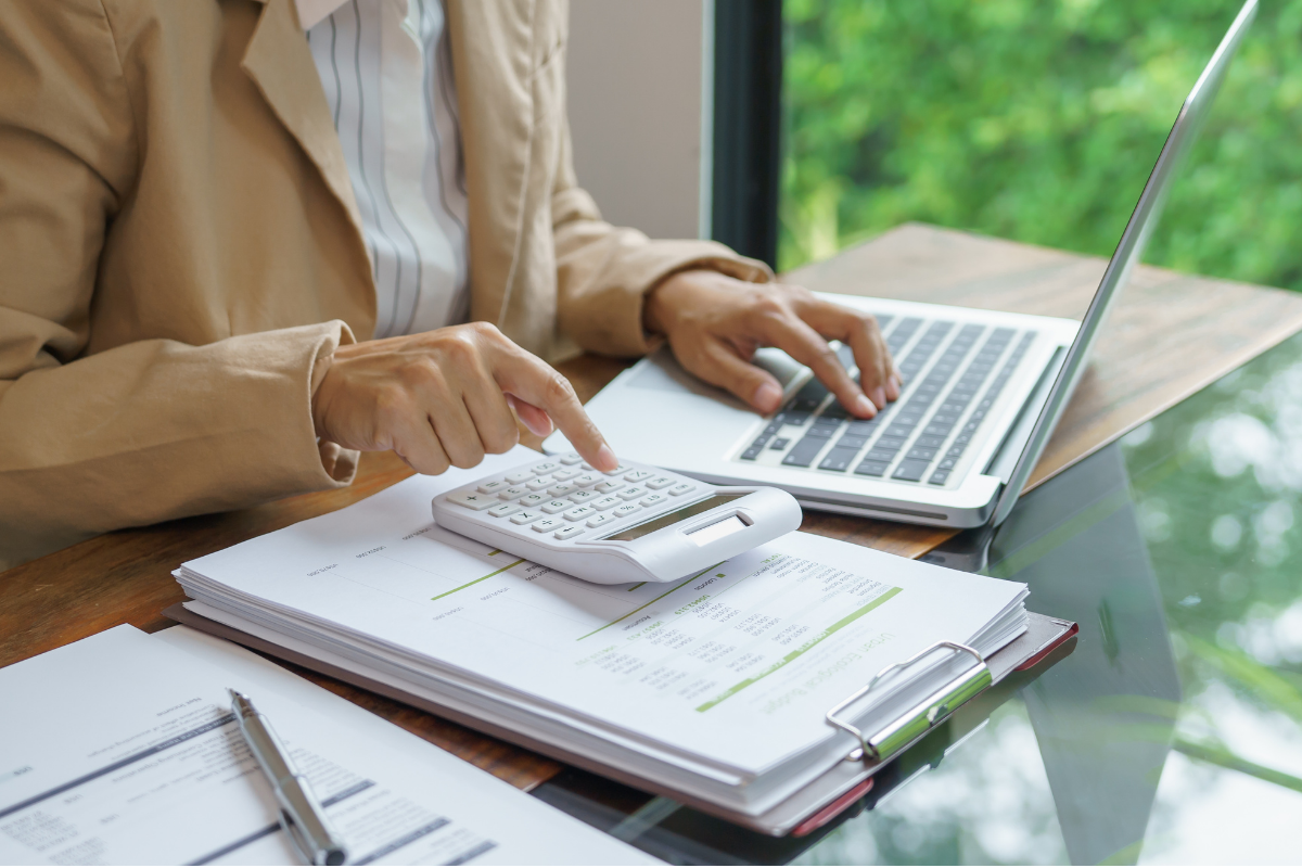 Comparing building cost figures using a calculator and laptop