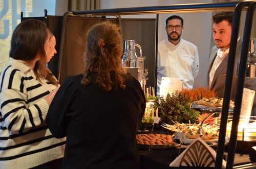 Customers looking at a catering display of food at event
