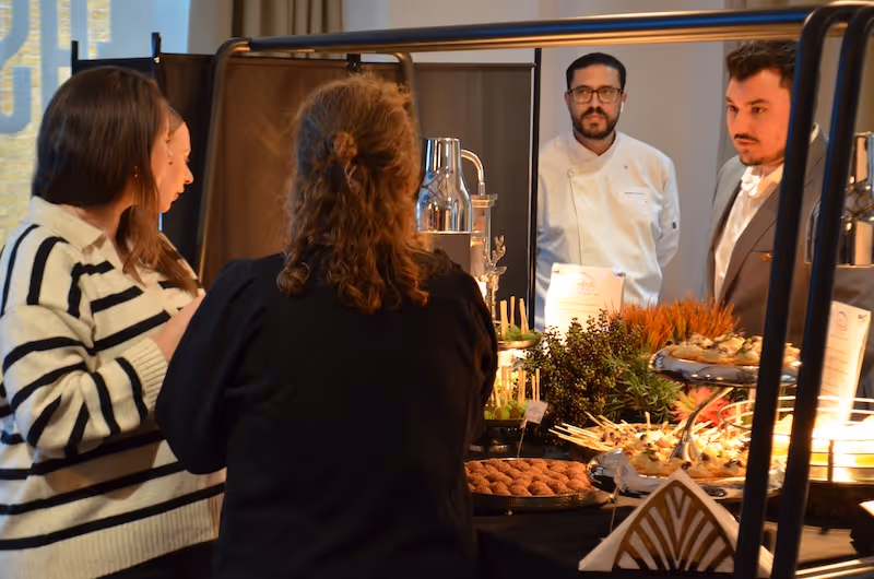 Customers looking at a catering display of food at event