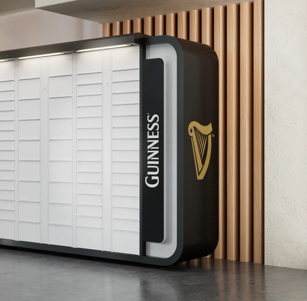 Modern black and white locker unit with Guinness branding and harp logo, set against a wood-paneled wall.