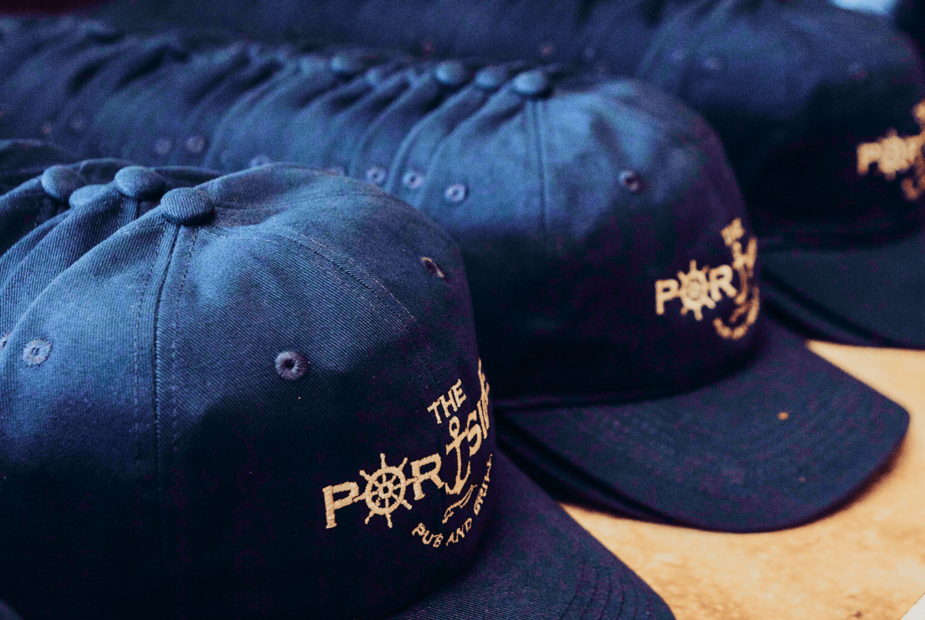 Various sections of Jeramiah's Pub, complete with bar seating, window booths, family tables, Alaskan memorobelia, and a view of the kitchen.