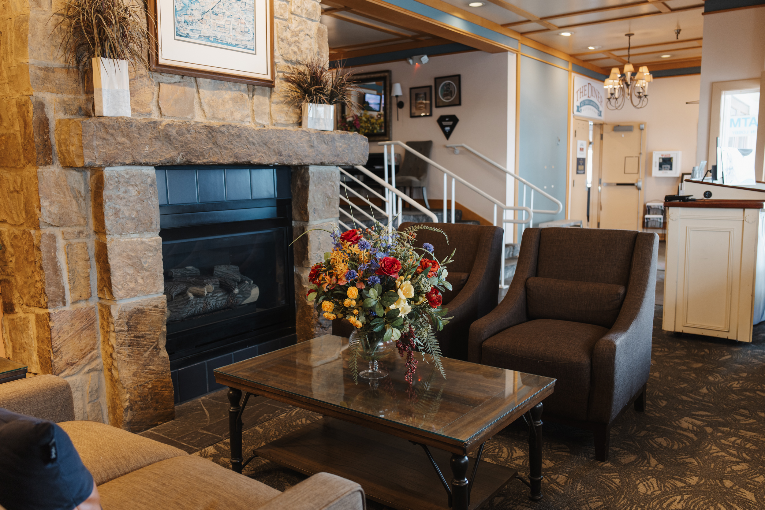 A warm guest area with a fireplace, mini library, and reading area.