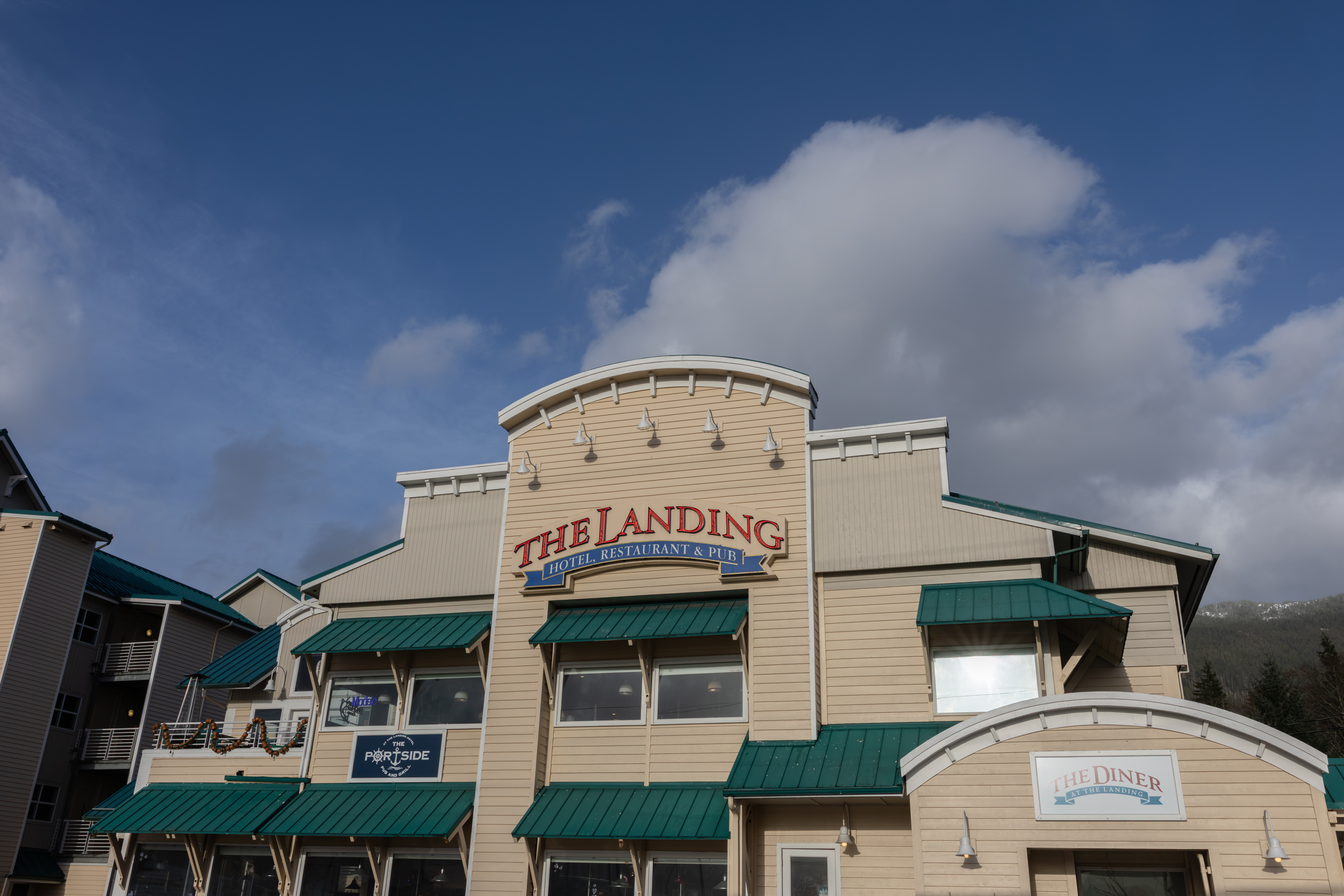 The Landing Clubhouse at dusk, full of patrons dining.