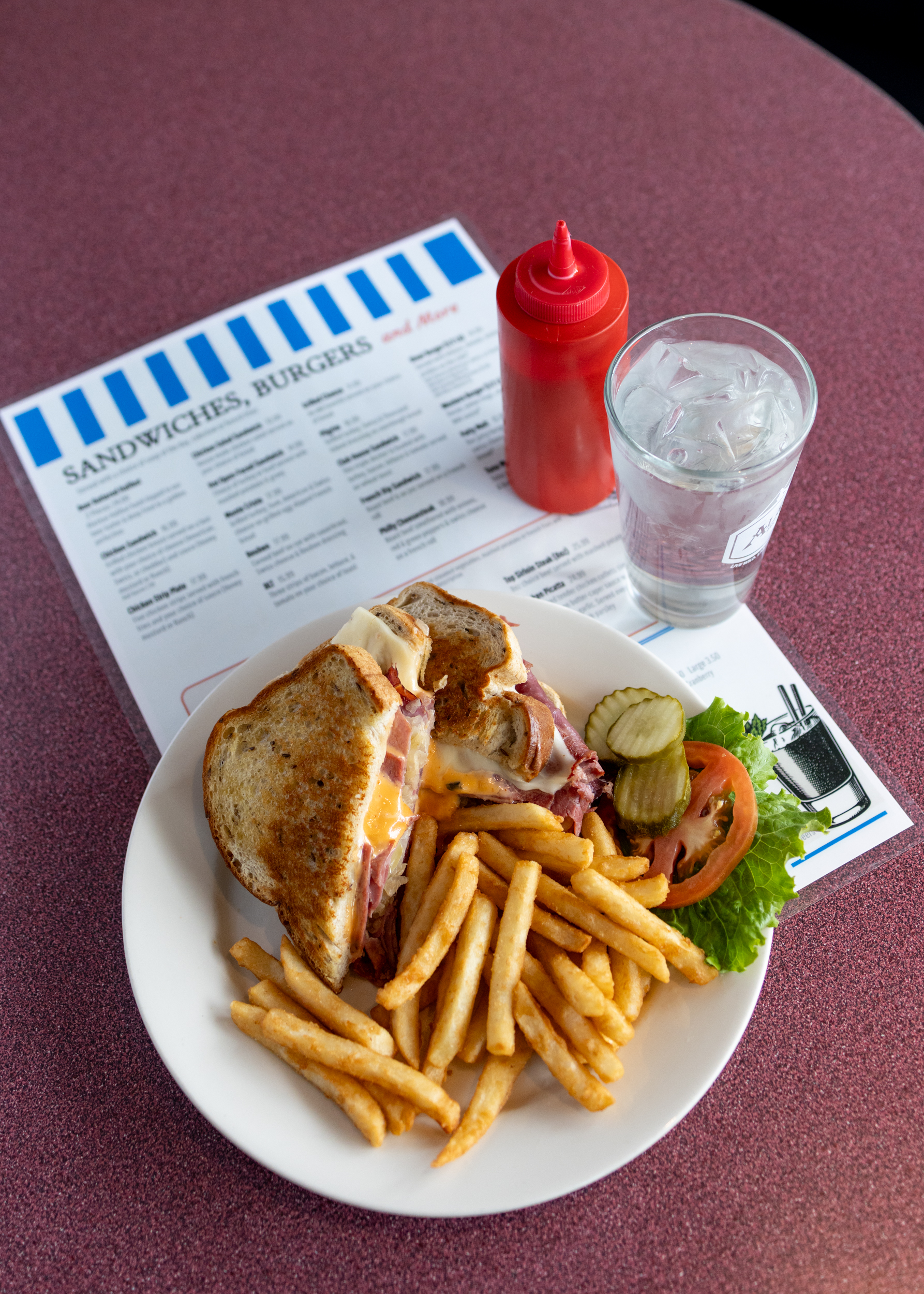 Comfortable booth seating at The Landing's Diner full of customers and home-style food.