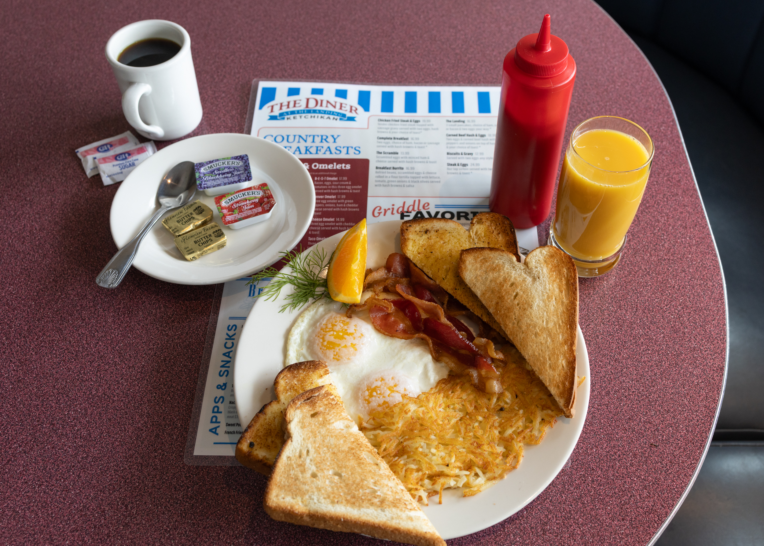Comfortable booth seating at The Landing's Diner full of customers and home-style food.