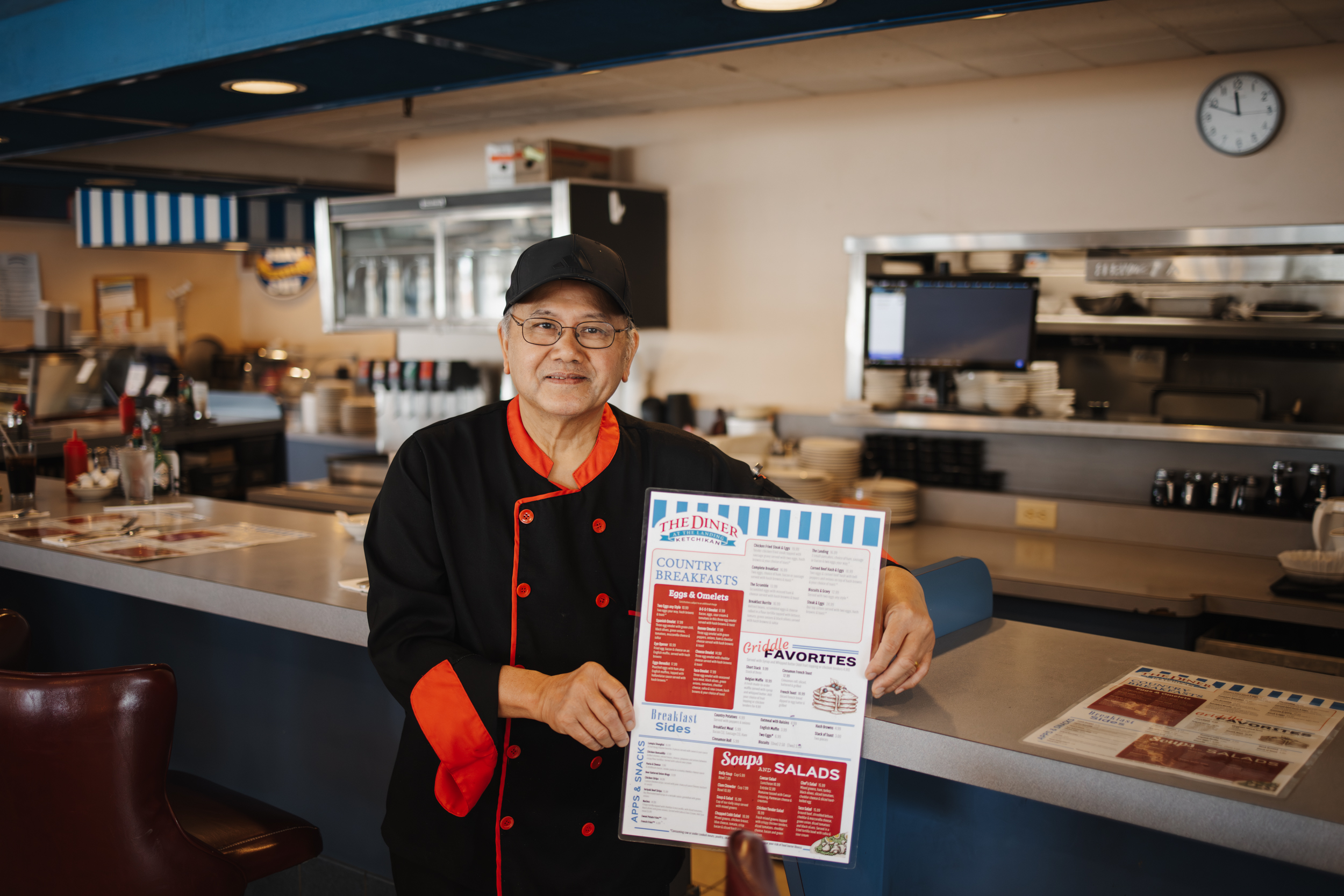 Comfortable booth seating at The Landing's Diner full of customers and home-style food.