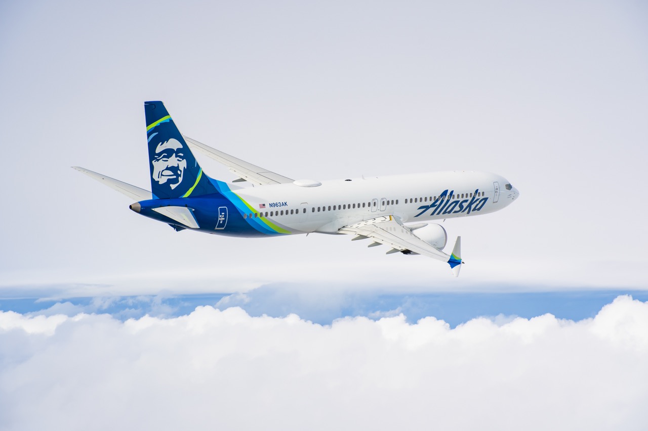 Alaska Airlines plane flying above the clouds on a route to Southeast Alaska.